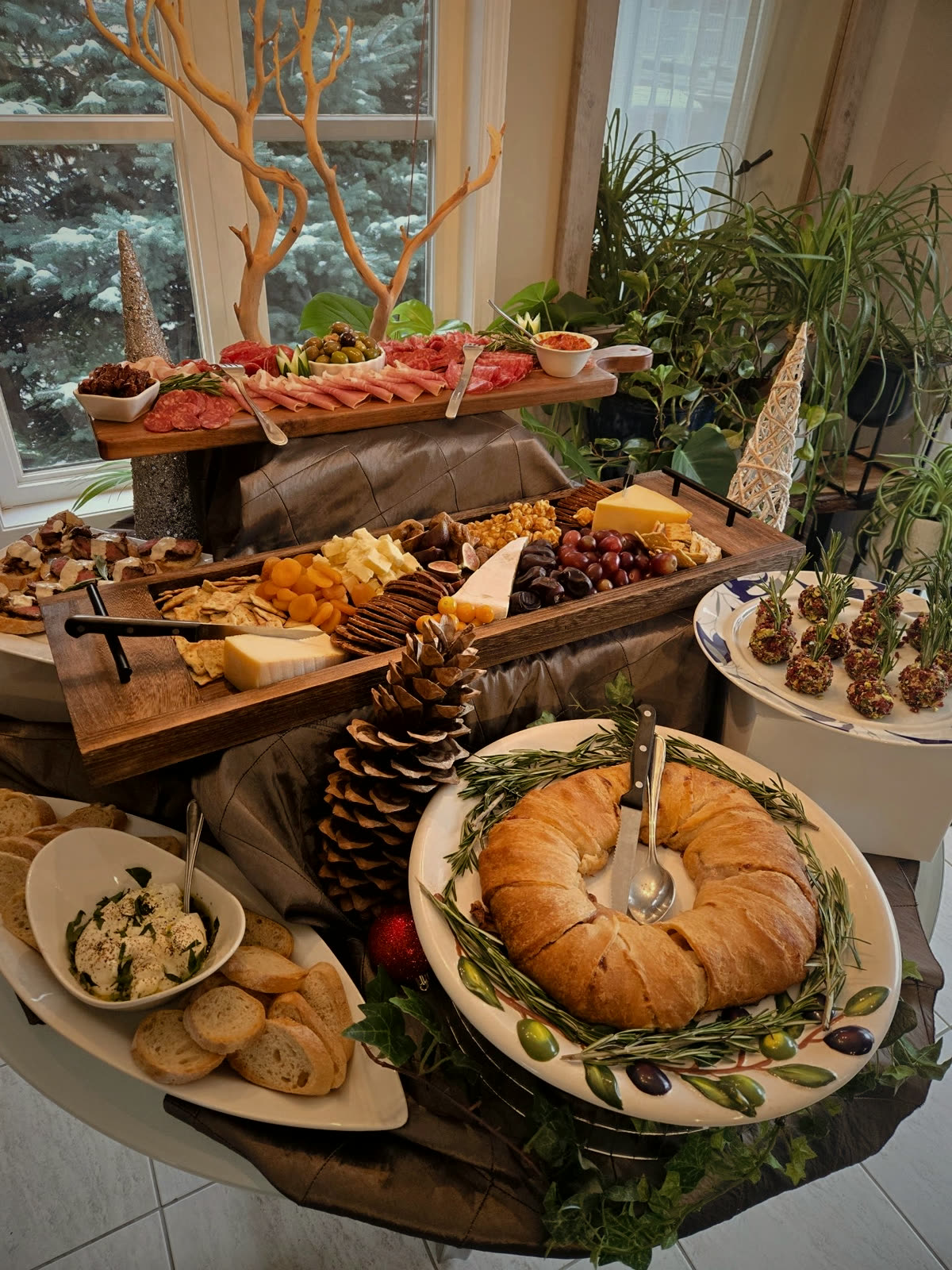 An abundant tiered spread of charcuterie, breads, cheeses and antipasto for an event