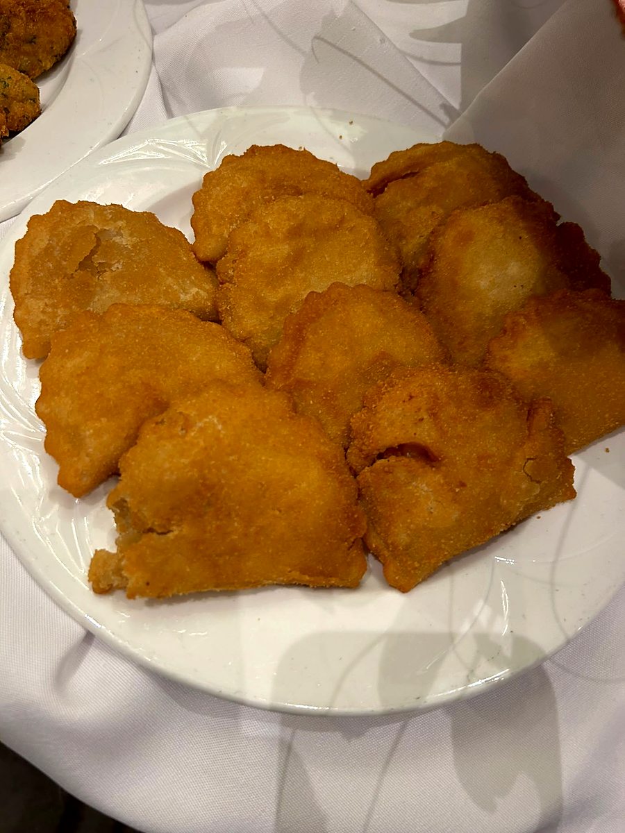 Lightly breaded filet of fish plated for a buffet line