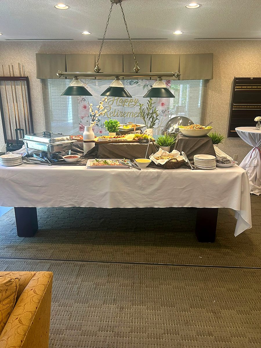 Buffet table fully set with chafing dishes and platters before guests arrive