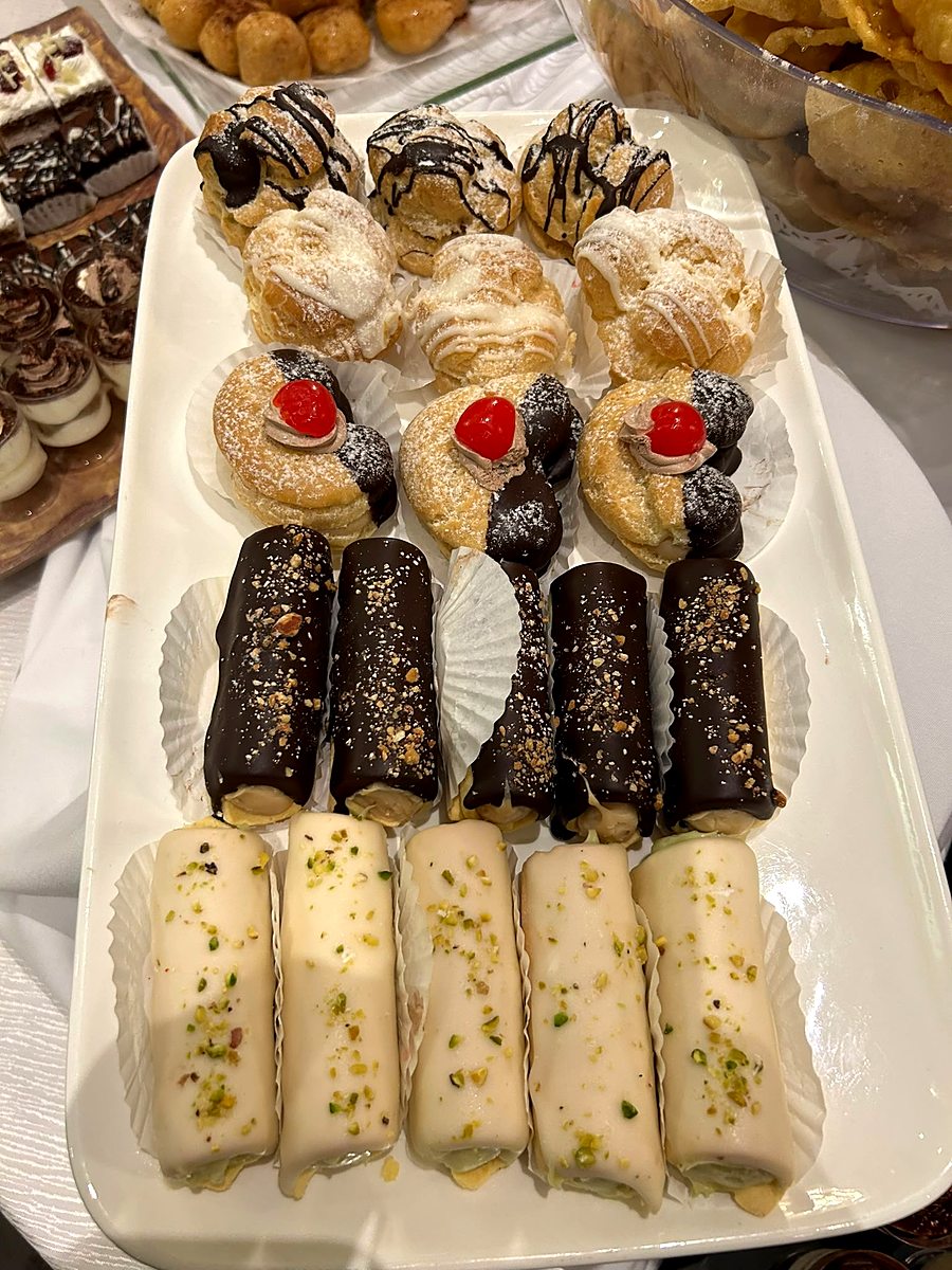 Tray of cannoli, eclairs and Portuguese pastries