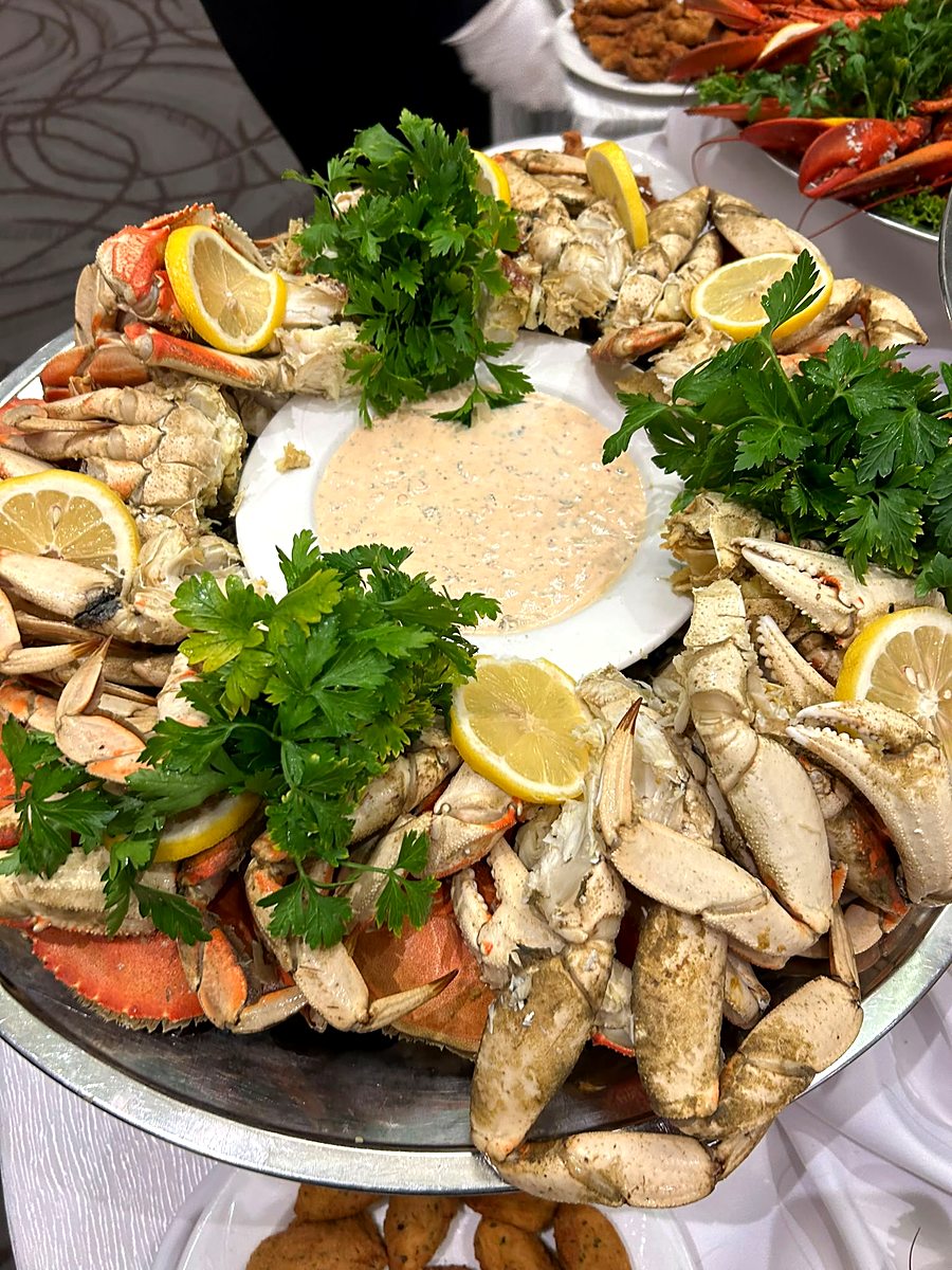 Dungeness crab platter arranged around a house-made dipping sauce