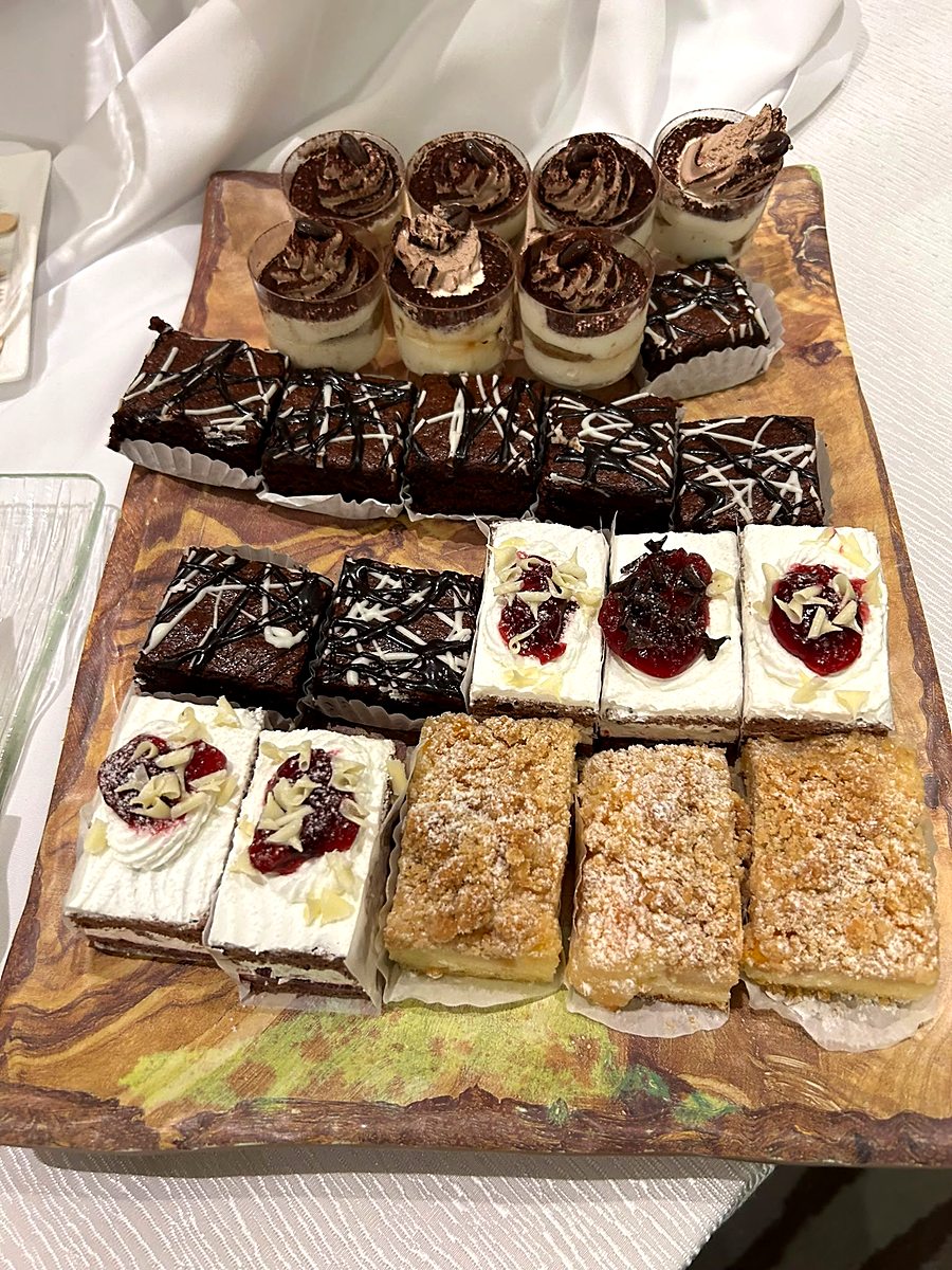 Dessert board with brownies, cheesecake squares and sweets