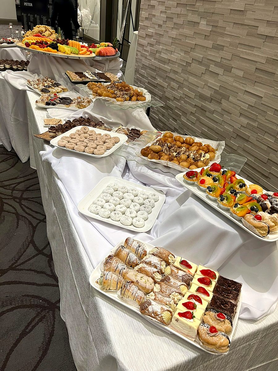 Long dessert table with pastries, cakes and sweets for an event