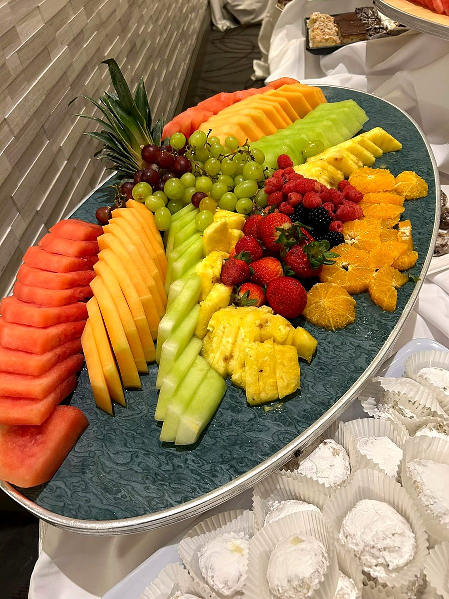 Large fresh fruit platter with melon, berries and pineapple