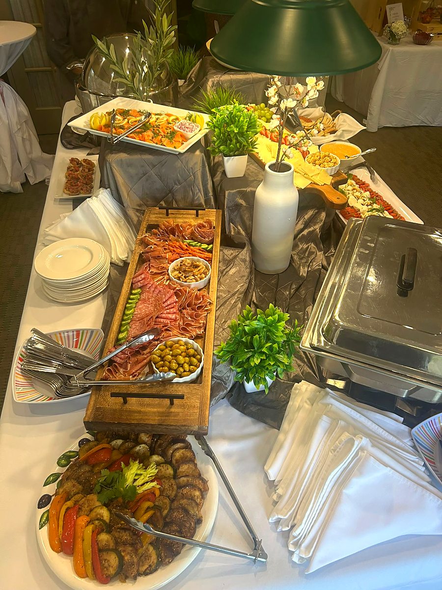 Grazing spread with hot chafing dishes at a private event