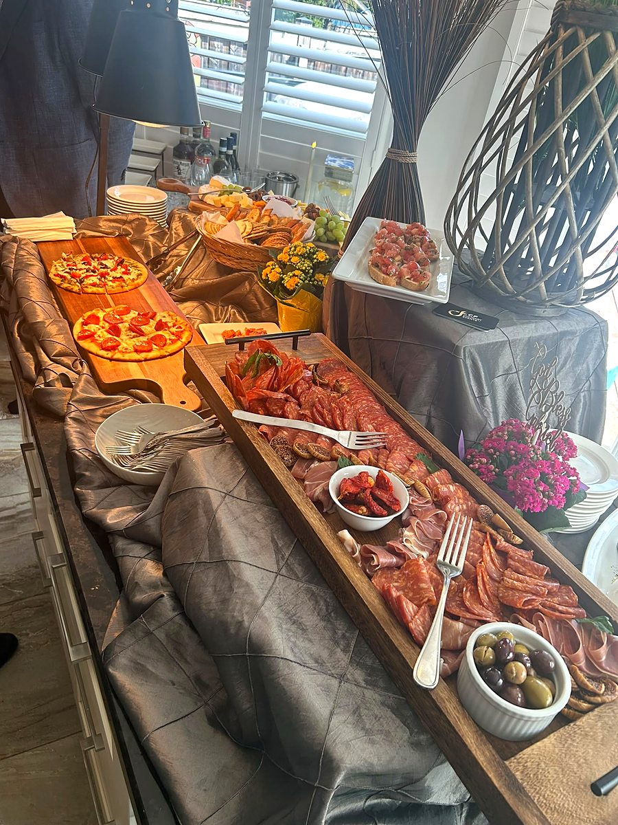 Wide grazing station with boards, platters and fresh garnishes