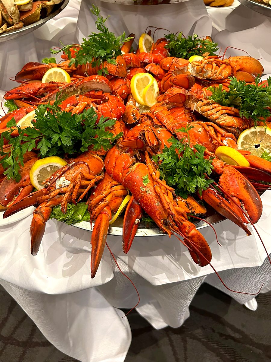 Close-up of cold lobster halves stacked high on a serving platter