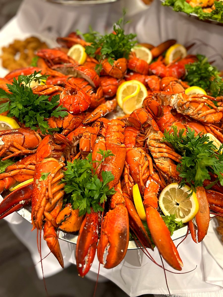 Whole Atlantic lobster platter garnished with lemon and parsley, ready for the seafood buffet