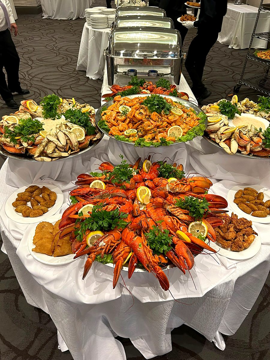 Full Portuguese seafood buffet table with lobster, crab, shrimp and cod croquettes