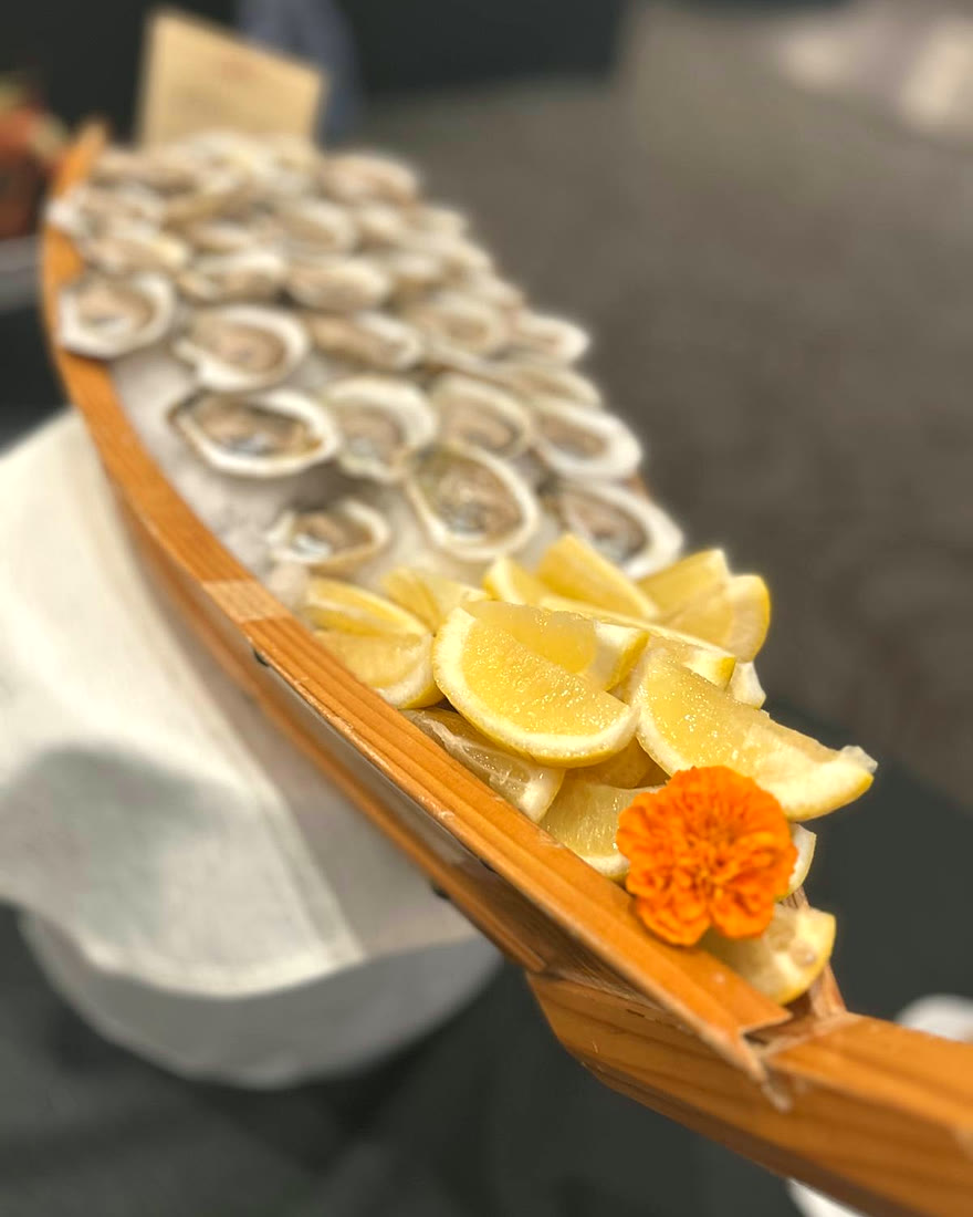 Oyster boat dressed with fresh lemon and marigold, styled for service by CF Culinary Events