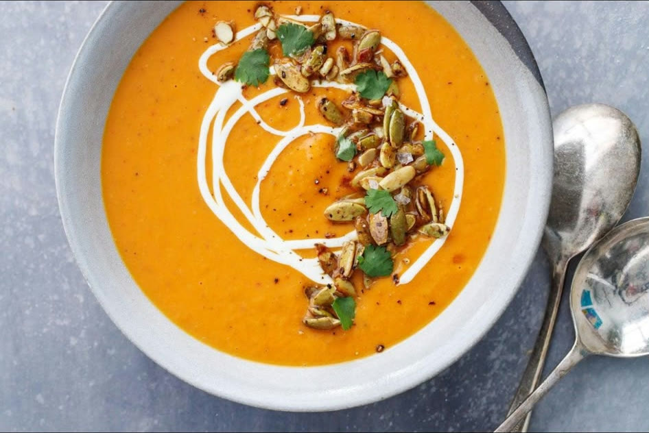 Roasted butternut squash bisque with a swirl of crème fraîche and toasted pumpkin seeds